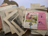 a pile of old newspapers sitting on top of a table