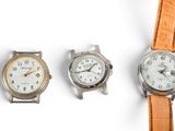 three different types of watches are displayed on a white surface