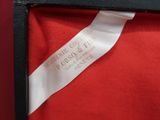 a red box that has a white ribbon on it
