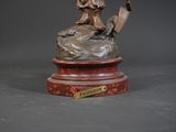 a bronze statue of a man holding an umbrella