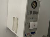 a water dispenser in the corner of a room