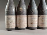 four bottles of wine are lined up on a table