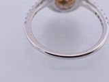 a close up view of a ring with a pearl and diamonds