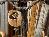 a statue of jesus on a cross with a shell in his hand