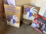 three books are sitting on a table next to a door