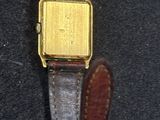 a watch that is sitting on a black surface