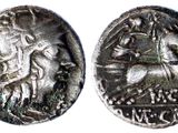 a close up of a coin with a man riding a horse on it