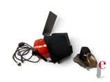 a red fire extinguisor sitting on the ground next to a pair of headphones