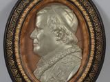 a close up of a metal plaque with a portrait of a man