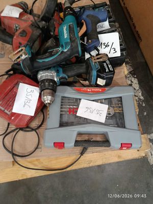 a pile of power tools on a pallet in a room