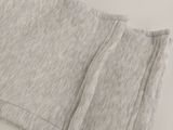 the bottom of a pair of gray sweat pants with a zipper on the side