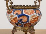 a decorative vase on a stand on a table