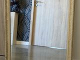 a large mirror sitting on the floor next to a door