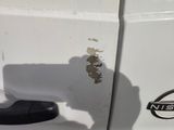 a close up of a car door handle with a rusted sticker on it