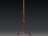 an old iron stand with a knife on top of it
