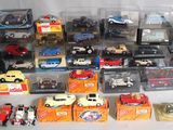 a lot of toy cars and other toys on a table