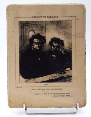 un vieux livre sur lequel figure l'image de deux hommes assis à une table