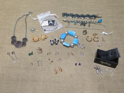 a lot of jewelry that is laying out on the floor