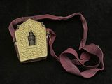 a small gold box with a picture of a person on it