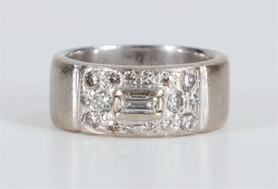 a close up of a diamond ring on a white surface