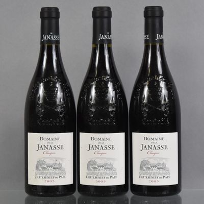 three bottles of red wine sitting on top of a table