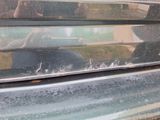 a close up of a car ' s front window with a dog in the back seat