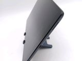 a black laptop sitting on a stand on a white surface