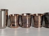 many different types of metal pipes lined up in a row
