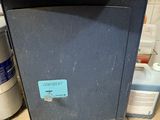 a black box sitting on the floor in the kitchen