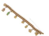a close up of a gold bracelet with charms on it