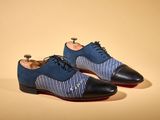 the shoes are blue and black with a white stripe on them