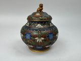 a large vase with a bird on it sitting on a table