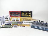 a lot of different model trains and accessories on the table