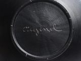 a close up of a black bowl with writing on it
