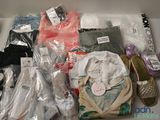 a box full of clothes and shoes that are on the table