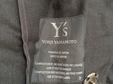 the back of a black jacket with a black label on it