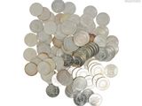 a pile of coins sitting on top of a white surface
