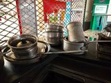 several pots and pans are on a stove top in a kitchen