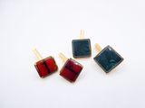 three pairs of red, green, and blue glass square earrings