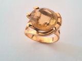 an image of a gold ring with a faceted citrine stone