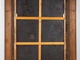 an old window with a wooden frame and a window pane in the middle