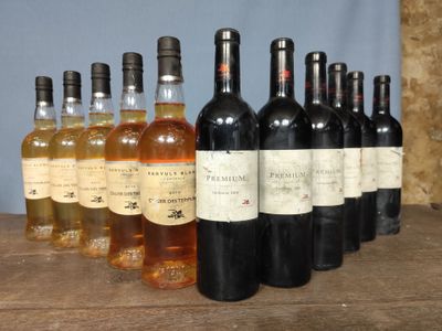 several bottles of wine are lined up on a wooden table
