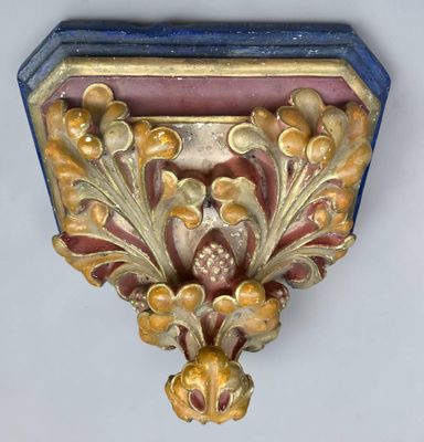a gold and blue shelf with a clock on it