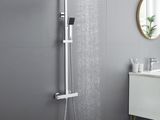 a close up of a shower head in a bathroom next to a sink