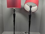 pair of black and red floor lamps with red lampshads