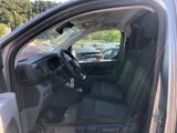 the interior of a car with the door open and the driver ' s seat down