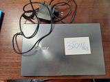 a laptop with a sign on it sitting on a desk