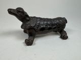 a small statue of a dog with a sweater on