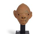statue of a man ' s head on a black stand on a white background
