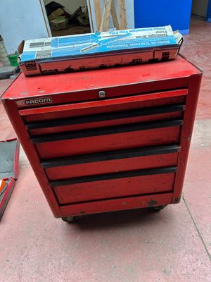 a red tool box sitting on top of a red cart